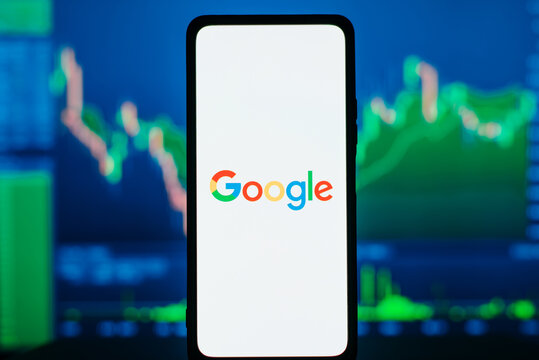 Google and investments, financial business concept. Google logo on smartphone against background of stock exchange profit graph. Astana, Kazakhstan 15.02.2023