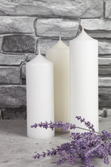 Three white candles with lavender