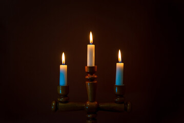 Candle flame on a dark background, symbol of prayer and remembrance.Religion concept.