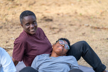 Fototapeta premium Two queer masculine women talking at the park 