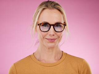 Woman, glasses style and portrait on pink background, studio backdrop and happiness. Happy female model, face and spectacles for fashion, eye care and vision of frames, cosmetic beauty or lens choice © Nina L/peopleimages.com
