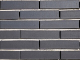 Textura de ladrillos con tono gris oscuro para pared exterior de edificios