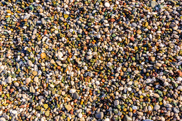 Texture of pebbles at the seaside. Natural background
