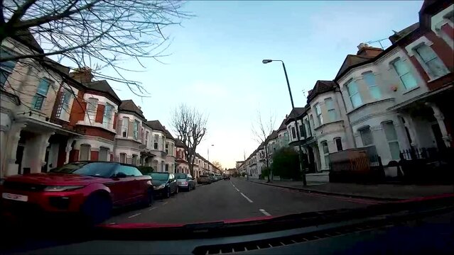 Timelapse of dash cam footage driving through London City at sunrise.