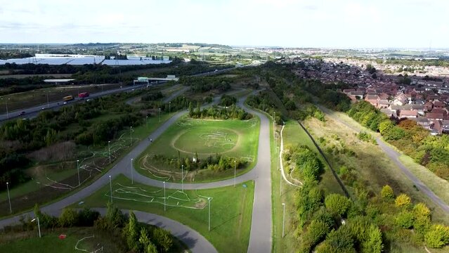 Drone rising over cycling track in London suburb. 