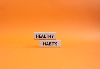 Healthy habits symbol. Concept word Healthy habits on wooden blocks. Beautiful orange background. Business and Healthy habits concept. Copy space