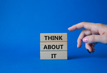 Think about it symbol. Wooden blocks with words Think about it. Beautiful blue background. Businessman hand. Business and Think about it concept. Copy space.