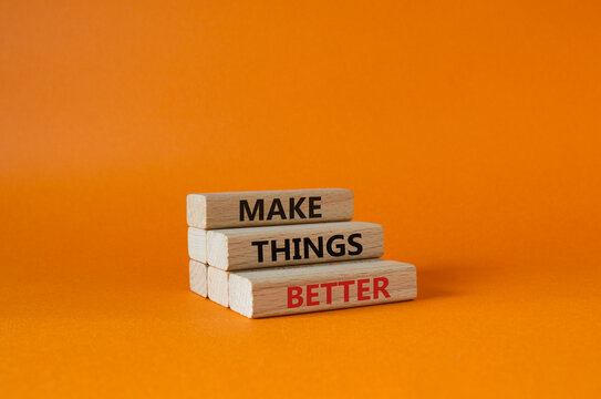 Make things better symbol. Concept word Make things better on wooden blocks. Beautiful orange background. Business and Make things better concept. Copy space