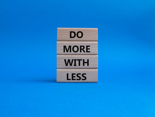 Do more with less symbol. Concept words Do more with less on wooden blocks. Beautiful blue background. Business and Do more with less concept. Copy space.