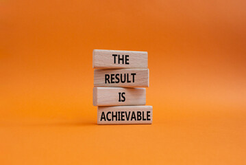 The result is achievable symbol. Concept words The result is achievable on wooden blocks. Beautiful orange background. Business and The result is achievable concept. Copy space.
