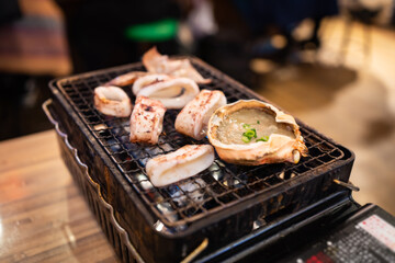 Kani Miso and baked squid on a grill
