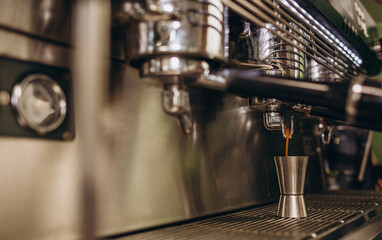 Italian espresso machine on a counter in a restaurant dispensing freshly brewed coffee