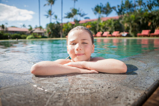 Girl taking break from swimming in pool