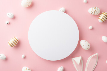 Naklejka na ściany i meble Easter celebration concept. Top view photo of white circle golden easter eggs and easter bunny ears on isolated pastel pink background with empty space