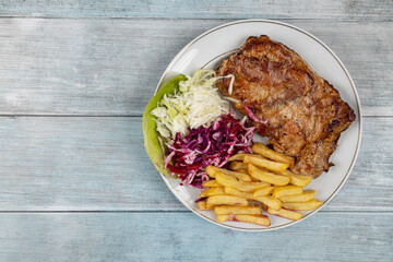 Meat stuffed with cheese and served with french fries and salad
