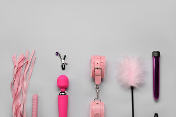 Different sex toys on grey background