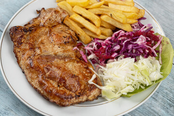 Meat stuffed with cheese and served with french fries and salad