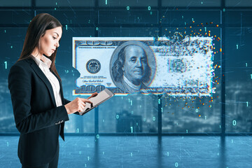 Attractive young european businesswoman using tablet with digital dollar bill on blurry tech office background with binary coding. Business and finance concept.