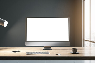 Front view on blank white modern computer monitor with place for your web site or web design on wooden table with coffee cup and keyboard on dark wall background in sunlit room. 3D rendering, mock up
