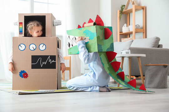 Little children in cardboard costumes playing at home