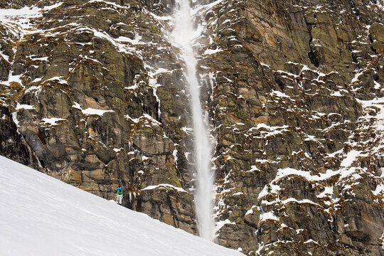 Snow falling down rocky cliff, Simplon Pass, Switzerland, Valais Canton, Switzerland