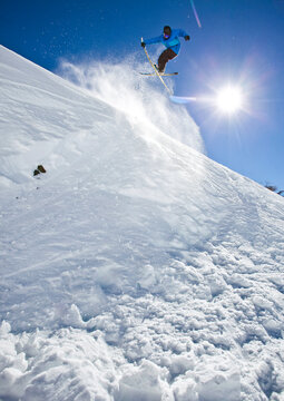 A Skier Hits A Jump And Grabs His Skies While Skiing At Cerro Catedral, Argentina