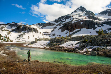 Hiker on riverbank at base of Locomotive Mountain,â€ Pemberton, British Columbia,â€ Canada