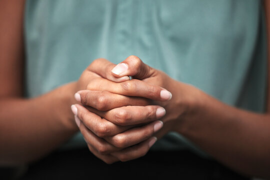Hands together, anxiety and praying in a psychology therapy session with mental health problem. Healthcare, god worship and hope hand gesture zoom of a black woman looking for support and help