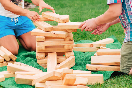 Close-up Of Hands Holding Wooden Blocks, Jenga, Game Concept, Outdoor Play For Kids And Adults