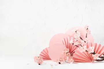 Foto auf Alu-Dibond Romantic tender floral spring background - branch pink sakura flowers, pink circles, paper fans on white table, mockup for presentation cosmetic products, goods, branding, design, card, poster, flyer. © finepoints