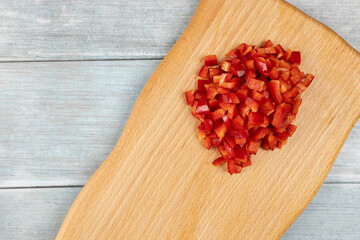 Chopped red paprika on the wooden board