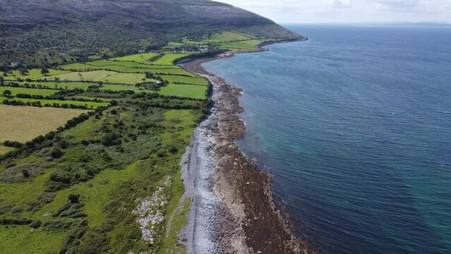 West of Ireland, the deep blue sea meets the green land on the edge of the Burren