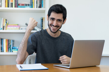 Successful israeli IT specialist at work at computer