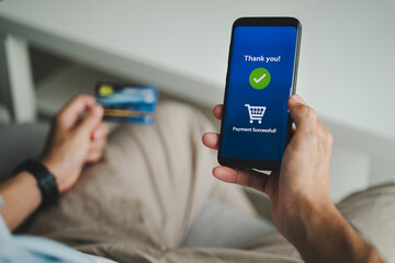 Man using credit card and smartphone for online shopping, Internet online banking transactions, e-commerce, spending money.