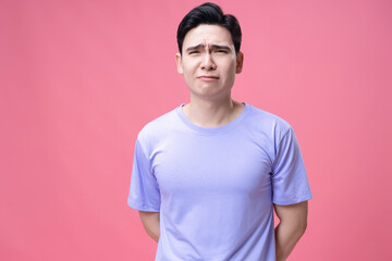 Portrait of young Asian man on background