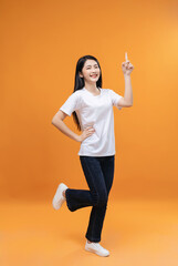 Full length image of young Asian girl on background