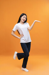 Fototapeta na wymiar Full length image of young Asian girl on background