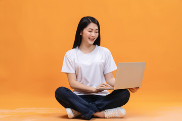 Young Asian girl using laptop on back ground