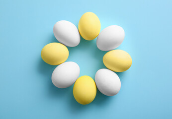 Composition with painted and natural Easter eggs on color background