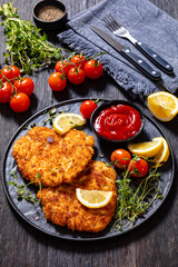 fried breaded chicken breast cutlets on plate