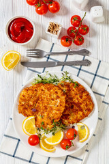 fried breaded chicken breast cutlets on plate