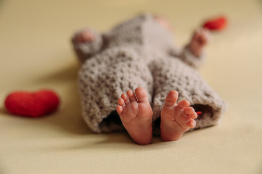 Legs of a newborn. Baby feet. The tiny foot of a newborn in soft selective focus. High quality photo
