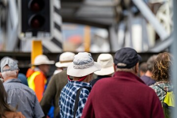 crowd of old people watching an event of boats outside in summer in australia