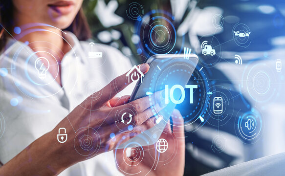 Businesswoman with phone and IOT icons, smart devices and connectivity
