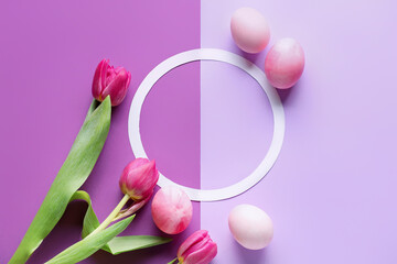 Obraz na płótnie Canvas Round frame, Easter eggs and beautiful tulip flowers on purple background