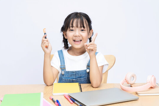 Photo of Asian kid studying on background