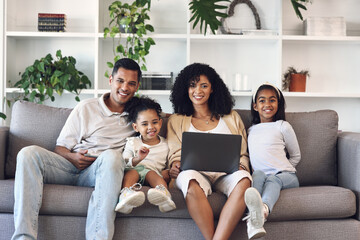 Family, home and laptop for portrait on couch while learning with online education, games or movie. Mother, father and girl kids together on couch with internet and parents teaching for development