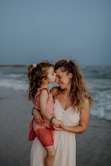 Mother enjoying together time with her daughter at sea.