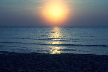 blue sea scape with sun set on blue sky background