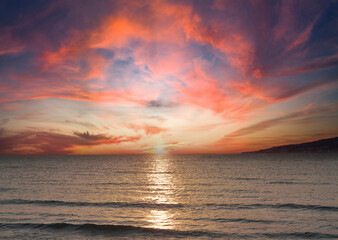 sunset on sea on dramatic sky background